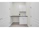 Bright laundry room with a sink, white cabinetry, and a dark countertop at 8772 S Sicily Ct, Aurora, CO 80016