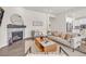 Bright living room features a fireplace with stone surround and contemporary furnishings at 8772 S Sicily Ct, Aurora, CO 80016