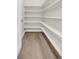 Walk-in pantry featuring shelving and wood floors at 8772 S Sicily Ct, Aurora, CO 80016