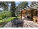 Backyard patio with an outdoor dining table and seating area under a covered porch at 5225 S Everett Ct, Littleton, CO 80123