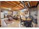 Finished basement featuring seating area, dining area, and wood-paneled walls at 5225 S Everett Ct, Littleton, CO 80123