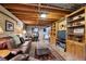 Finished basement with a leather couch, wood trim, and a dining area with table at 5225 S Everett Ct, Littleton, CO 80123