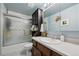 Cozy bathroom featuring tub with shower, vanity with storage, and tiled floors for easy maintenance at 5225 S Everett Ct, Littleton, CO 80123