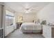 Well-lit bedroom featuring white walls, a ceiling fan, and a bright window overlooking the lawn at 5225 S Everett Ct, Littleton, CO 80123