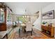 Bright dining area featuring a large window, hardwood floors, and decorative furnishings at 5225 S Everett Ct, Littleton, CO 80123