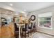 Open kitchen features a granite island with seating, modern lighting, and ample counter space at 5225 S Everett Ct, Littleton, CO 80123