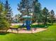 Community playground with swings, slides, benches, and mature trees at 5225 S Everett Ct, Littleton, CO 80123