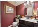 Charming powder room features dark cabinetry, decorative walls, and classic fixtures, offering style and convenience at 5225 S Everett Ct, Littleton, CO 80123