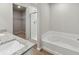 Bathroom with a walk-in shower, soaking tub, and granite countertops at 2174 Alyssa St, Fort Lupton, CO 80621