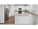 Modern kitchen with stainless steel appliances, granite countertops, stylish cabinets and hardwood floors at 2174 Alyssa St, Fort Lupton, CO 80621