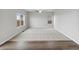 Large, airy living room featuring neutral walls, plush carpet and sleek, modern ceiling fan at 2174 Alyssa St, Fort Lupton, CO 80621