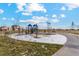 Community playground features swings, climbing structure, and slide with green space at 2174 Alyssa St, Fort Lupton, CO 80621