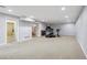 Spacious basement featuring neutral carpet, updated lighting and brick fireplace, ideal for Gathering activities at 4231 W Ponds Cir, Littleton, CO 80123