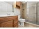 Updated bathroom features a glass door shower with tile surround, single sink and vanity at 4231 W Ponds Cir, Littleton, CO 80123