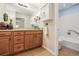Bathroom featuring wooden cabinets, tiled floor, and shower with glass door at 4231 W Ponds Cir, Littleton, CO 80123