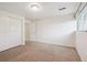 Bright bedroom offers carpeted floors, a large window and closet with bi-fold doors at 4231 W Ponds Cir, Littleton, CO 80123