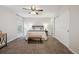 Bright bedroom with ceiling fan, carpet and ample closet space at 4231 W Ponds Cir, Littleton, CO 80123