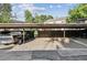 Carport view showing the number 4231, parking spaces, and a dark wood fence at 4231 W Ponds Cir, Littleton, CO 80123