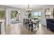 Bright dining area features a chandelier, patio door and backyard views at 4231 W Ponds Cir, Littleton, CO 80123