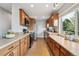 Well-lit kitchen with wooden cabinets, stainless steel appliances, and a bright window at 4231 W Ponds Cir, Littleton, CO 80123