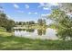 Beautiful backyard pond surrounded by lush greenery, offering a serene and tranquil setting at 4231 W Ponds Cir, Littleton, CO 80123