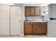 Basement wet bar featuring tile floors, upper and lower cabinets and sink at 4231 W Ponds Cir, Littleton, CO 80123
