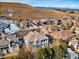 Aerial view of houses in a neighborhood, with a mountain in the background and patches of snow at 10488 Bluffmont Dr, Lone Tree, CO 80124
