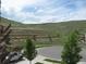 View of backyard hillside landscaping and retaining walls overlooking street at 10488 Bluffmont Dr, Lone Tree, CO 80124