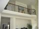 Interior balcony overlooking living area with custom iron railing at 10488 Bluffmont Dr, Lone Tree, CO 80124