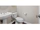 Powder room featuring a pedestal sink and a modern toilet at 10488 Bluffmont Dr, Lone Tree, CO 80124