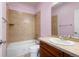 Charming bathroom featuring a vanity with tile countertop, and a shower and bathtub combo at 10488 Bluffmont Dr, Lone Tree, CO 80124