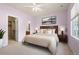 Stylized primary bedroom with walk-in closet and ensuite bathroom at 10488 Bluffmont Dr, Lone Tree, CO 80124