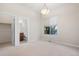Inviting bedroom with neutral carpet, a large window, and an ensuite bathroom, offering a private retreat at 10488 Bluffmont Dr, Lone Tree, CO 80124