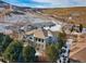 Aerial view of home surrounded by mature trees and mountain backdrop at 10488 Bluffmont Dr, Lone Tree, CO 80124