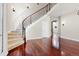 Elegant foyer with hardwood floors and a curved staircase at 10488 Bluffmont Dr, Lone Tree, CO 80124