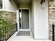 Front door with stone accents and concrete pathway at 10488 Bluffmont Dr, Lone Tree, CO 80124