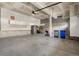 Spacious garage with stairs, work area, and plenty of room for storage and vehicles at 10488 Bluffmont Dr, Lone Tree, CO 80124