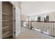 Upstairs hallway featuring a built-in storage closet and views to the floor below at 10488 Bluffmont Dr, Lone Tree, CO 80124