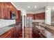 Well-equipped kitchen features stainless steel appliances and dark wood cabinetry at 10488 Bluffmont Dr, Lone Tree, CO 80124