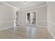 Open-concept living room with French doors and modern lighting at 10488 Bluffmont Dr, Lone Tree, CO 80124
