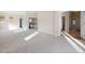 Large, bright living room with neutral walls, large windows, and access to a bathroom with a shower and tub at 10488 Bluffmont Dr, Lone Tree, CO 80124