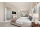 Inviting main bedroom with a chandelier, a seating area, and a king-sized bed with lots of pillows at 10488 Bluffmont Dr, Lone Tree, CO 80124