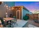 Charming patio area with string lights, a table with chairs, and a storage shed in backyard at 744 Grand Market Ave, Berthoud, CO 80513