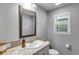 Clean bathroom featuring a granite vanity, framed mirror, and a toilet with white walls at 744 Grand Market Ave, Berthoud, CO 80513