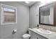 Bright bathroom featuring a granite vanity, framed mirror, and a walk-in shower with white walls at 744 Grand Market Ave, Berthoud, CO 80513