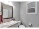 Cozy bathroom featuring a granite vanity, framed mirror, and a toilet with white walls at 744 Grand Market Ave, Berthoud, CO 80513