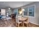 Open concept dining area and living room with natural light and hardwood floors at 744 Grand Market Ave, Berthoud, CO 80513