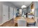 Bright dining room with hardwood floors and natural light, next to a large open living area at 744 Grand Market Ave, Berthoud, CO 80513