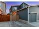 Exterior view with a fenced backyard, a garage, and contemporary architecture at 744 Grand Market Ave, Berthoud, CO 80513