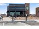 Commercial building exterior showcasing sustainable features like EV charging stations and outdoor seating at 744 Grand Market Ave, Berthoud, CO 80513